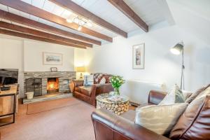 a living room with a couch and a fireplace at 2 Bed in Bodmin oc-p00429 in Saint Teath