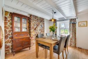 a dining room with a wooden table and chairs at 2 Bed in Bodmin oc-p00429 in Saint Teath +10 photos