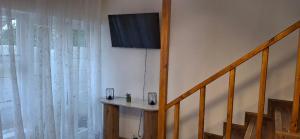 a room with a staircase with a window and a table at Serenity Green House near Constantia Winelands in Square Hill