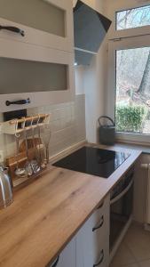 a kitchen with a counter with a sink and a window at Ferienwohnung Stadtblick Königstein in Königstein an der Elbe