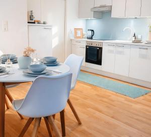 a kitchen with a table and chairs in a room at Suites in Mödling in Mödling