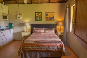 a bedroom with a bed with a striped bedspread at Gallery Inn in Bela-Bela +46 photos