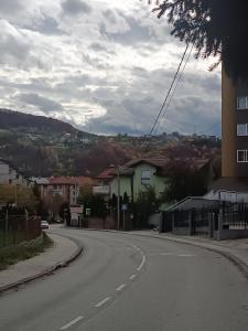 an empty street in a town with a building at Apartment Imamović in Vogošća