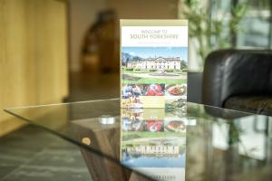 a glass table with a sign on top of it at The Welcome Inn in Rotherham