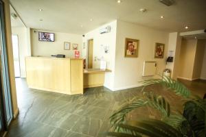 a waiting room with a reception desk in a building at The Welcome Inn in Rotherham
