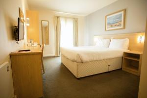 a hotel room with a bed and a window at The Welcome Inn in Rotherham