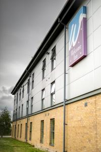 a building with a sign on the side of it at The Welcome Inn in Rotherham +9 photos