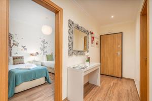 a small room with a bed and a mirror at #010 Marina View Apartment Pool & Balcony in Albufeira +31 photos