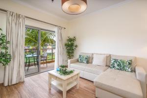 a living room with a couch and a table at #010 Marina View Apartment Pool & Balcony in Albufeira