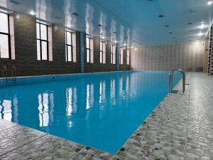a large pool with blue water in a building at Imperial Hotel in Kapan +42 photos