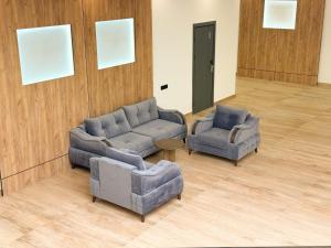 a living room with two couches and two chairs at Imperial Hotel in Kapan