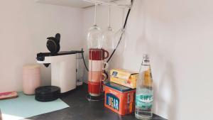 a kitchen counter with two glass bottles and a blender at Studioraum nähe Koblenz in Sankt Sebastian