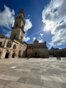 a large building with a clock tower in a courtyard at n CELI in Uggiano la Chiesa