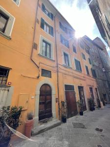 a building with doors and windows on a street at APPARTAMENTO SULLA SALA in Pistoia