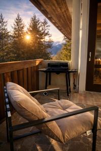 a bed on a porch with a view of a piano at Chalet DolceVista con SPA, vicino a Cortina d'Ampezzo in Borca di Cadore