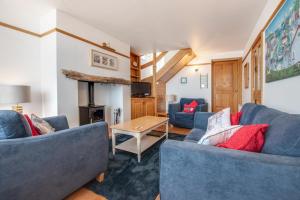 a living room with two blue couches and a table at 2 Bed in Sandsend oc-wa317 in Sandsend