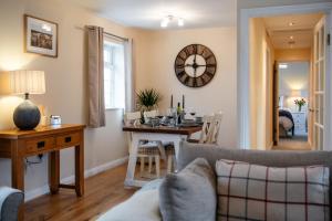 a living room with a couch and a dining room at Wynmere Cottage in Chipping Norton
