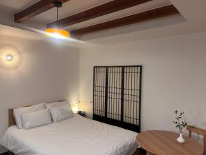 a bedroom with a white bed and a table at Stay Us 3151 in Seongnam