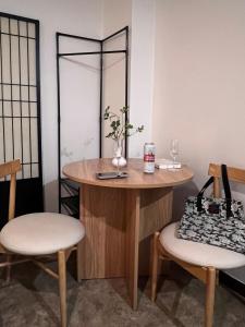 a dressing table with two chairs and a mirror at Stay Us 3151 in Seongnam