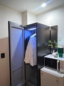 a kitchen with a refrigerator and a microwave at Stay Us 3151 in Seongnam
