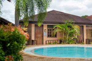 a house with a swimming pool in front of a house at West Peninsula Villas in Harrison
