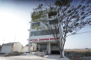 a building with a tree in front of it at Hotel Shubh Bodhi in Bodh Gaya +17 photos