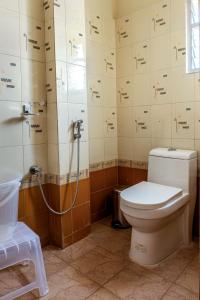 a bathroom with a toilet and a shower at Hotel M S Chola in Chennai
