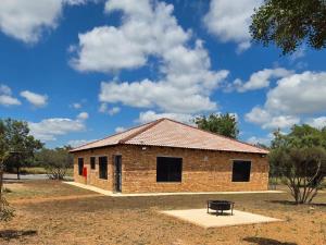 a brick building with a bench in front of it at Bush Diamond Lodge in Cullinan