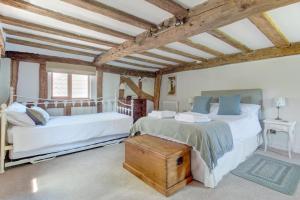 two beds in a room with wooden ceilings at 4 Bed in Walpole oc-brof in Walpole +15 photos