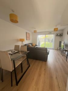 a living room with a couch and a table at The Lakes in Stockingford