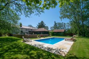 a swimming pool in a yard with two benches at 4 Bed in Walpole oc-brof in Walpole