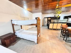 a room with two bunk beds and a dining room at Casas Villa azul in Tanti