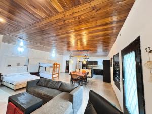 a living room with a couch and a bed at Casas Villa azul in Tanti