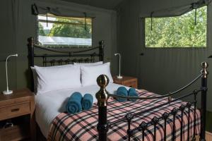 a bedroom with a bed with blue towels on it at 3 Bed in Talybont-on-Usk oc-wal374 in Talybont