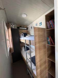 a small room with a bed and a desk at Mobile Home Clelia in Sveti Petar