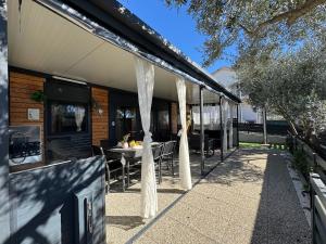a house with a table and chairs on a patio at Mobile Home Clelia in Sveti Petar +38 photos