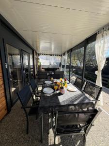a table with plates of food on top of a house at Mobile Home Clelia in Sveti Petar