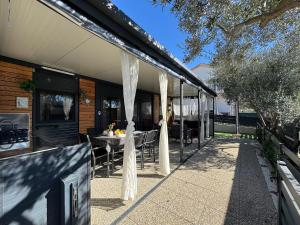 a patio with a table and chairs on a house at Mobile Home Clelia in Sveti Petar