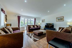 a living room with couches and a tv at 4 Bed in Tenby oc-t27576 in Tenby