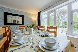 a dining room with a table with dishes on it at 4 Bed in Tenby oc-t27576 in Tenby