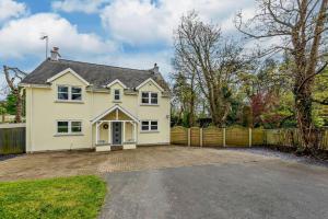 a white house with a fence and a driveway at 4 Bed in Tenby oc-t27576 in Tenby