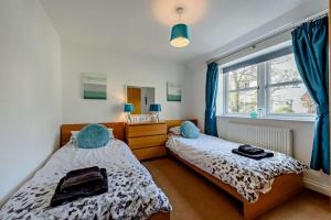 a bedroom with two beds and a window at 4 Bed in Tenby oc-t27576 in Tenby