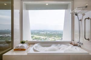 a bath tub in a bathroom with a large window at White Sands Beach-Beach Access-1BR-Amazing View2 in Na Jomtien +19 photos