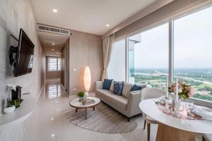 a living room with a couch and a table at White Sands Beach-Beach Access-1BR-Amazing View2 in Na Jomtien