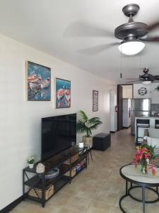 a living room with a large flat screen tv at Beach vibes condo in Luquillo in Luquillo