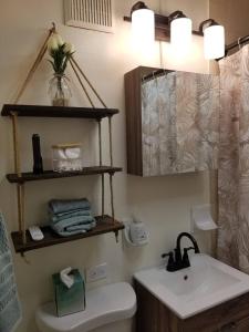 a bathroom with a white toilet and a sink at Beach vibes condo in Luquillo in Luquillo +62 photos