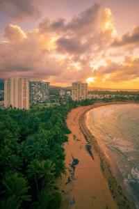 a view of a beach with buildings and the ocean at Beach vibes condo in Luquillo in Luquillo