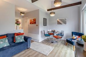 a living room with a blue couch and a table at 2 Bed in Chapel Stile oc-gl103 in Chapel Stile