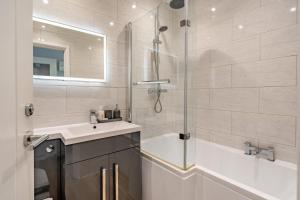 a bathroom with a shower and a sink and a tub at 2 Bed in Chapel Stile oc-gl103 in Chapel Stile +11 photos