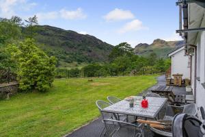 a table and chairs on the porch of a house at 2 Bed in Chapel Stile oc-gl103 in Chapel Stile